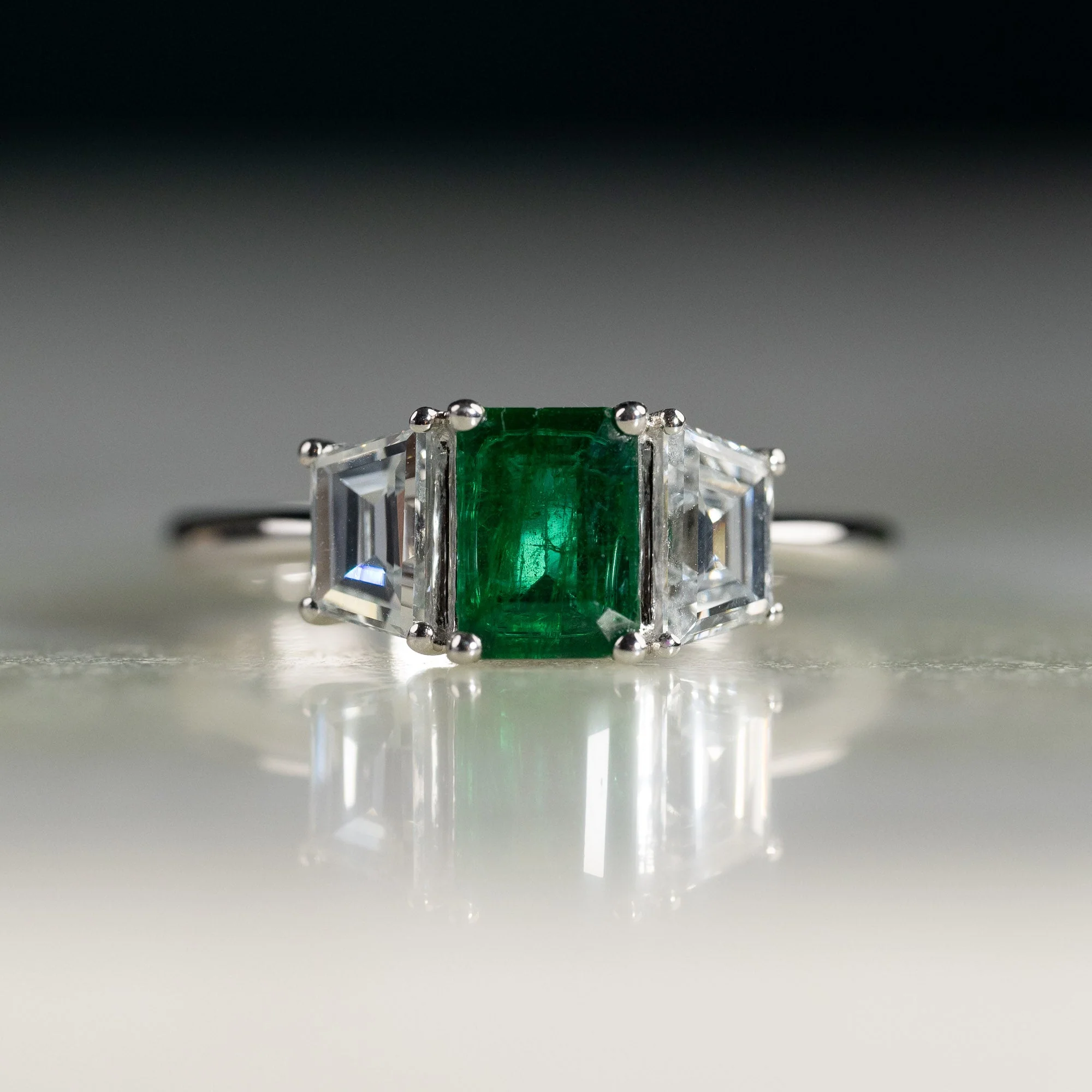 THREE-STONE 1.0ct EMERALD & TRAPEZOID DIAMOND RING