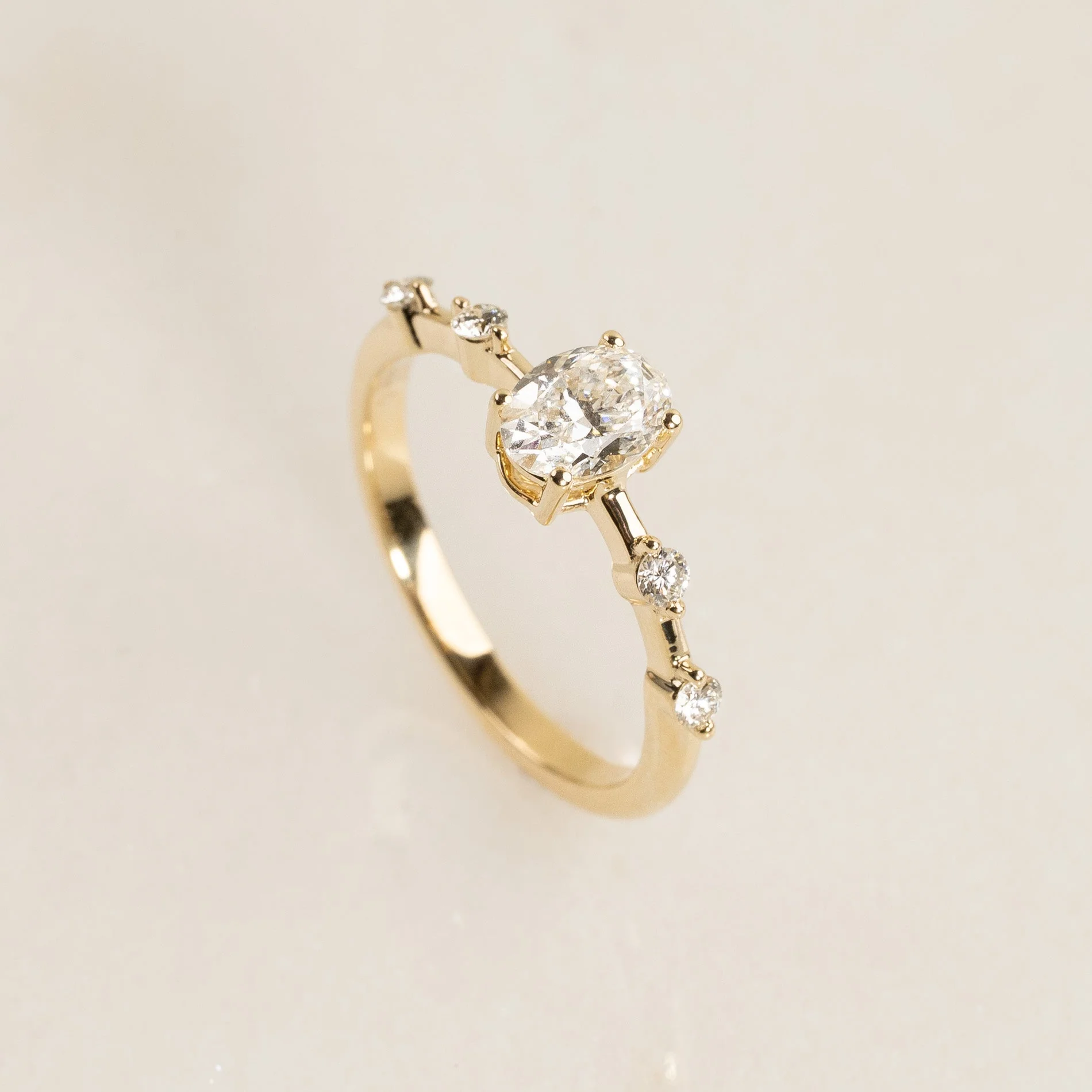 OVAL-CUT SIDESTONE DIAMOND RING - 0.70ct
